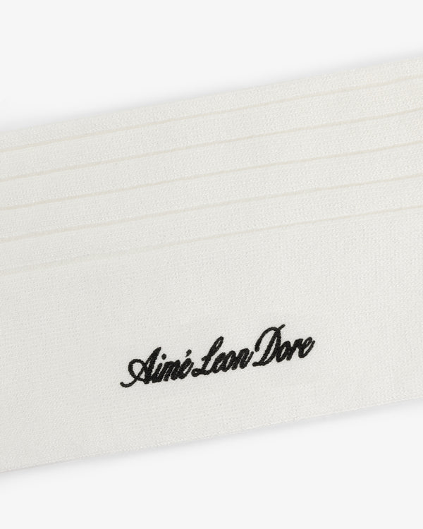 White dress sock with horizontal stitched lines and Aimé Leon Dore embroidered in black cursive.