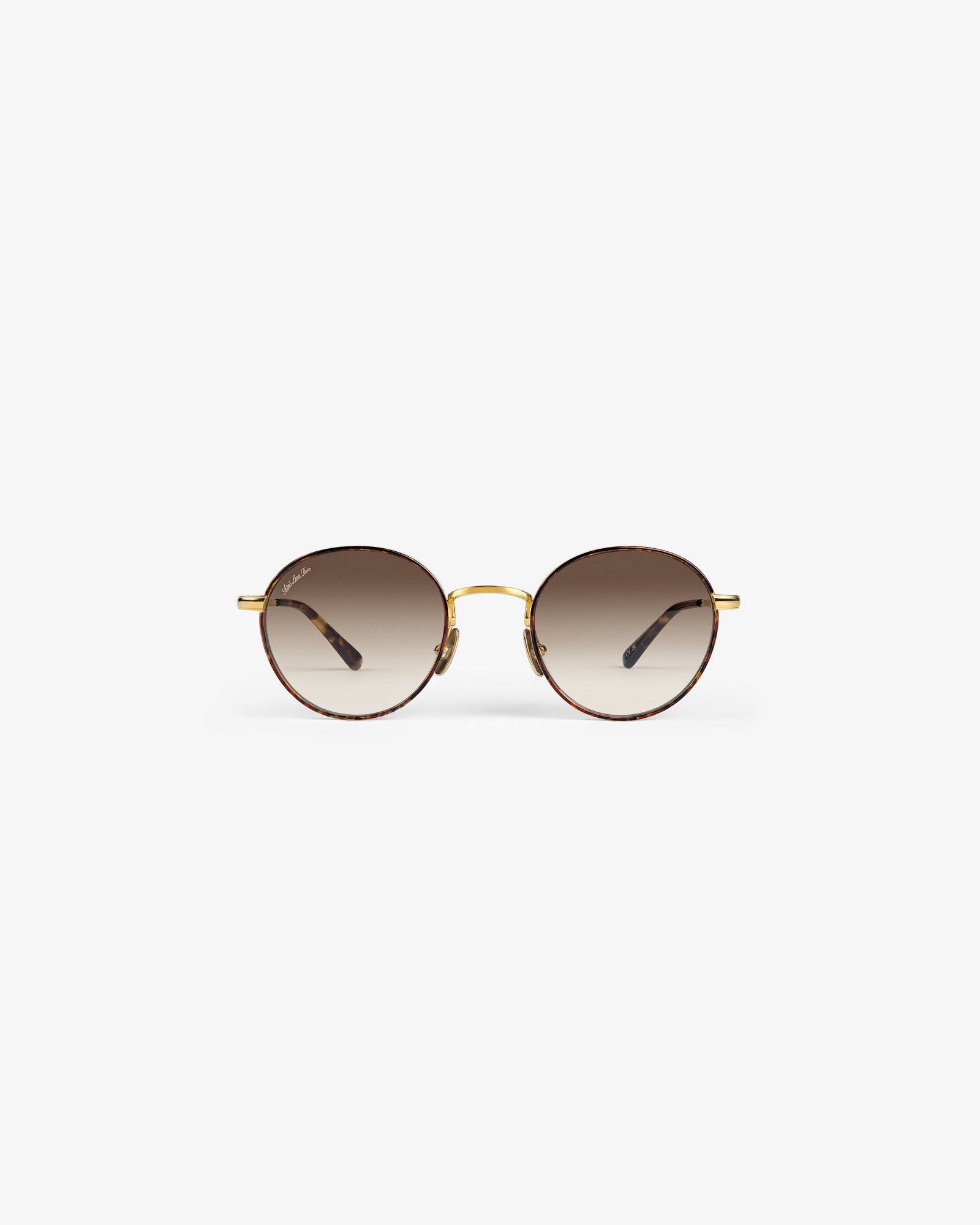 Giórgios Sunglasses: round tortoiseshell frames, brown gradient lenses, gold bridge on a white background.