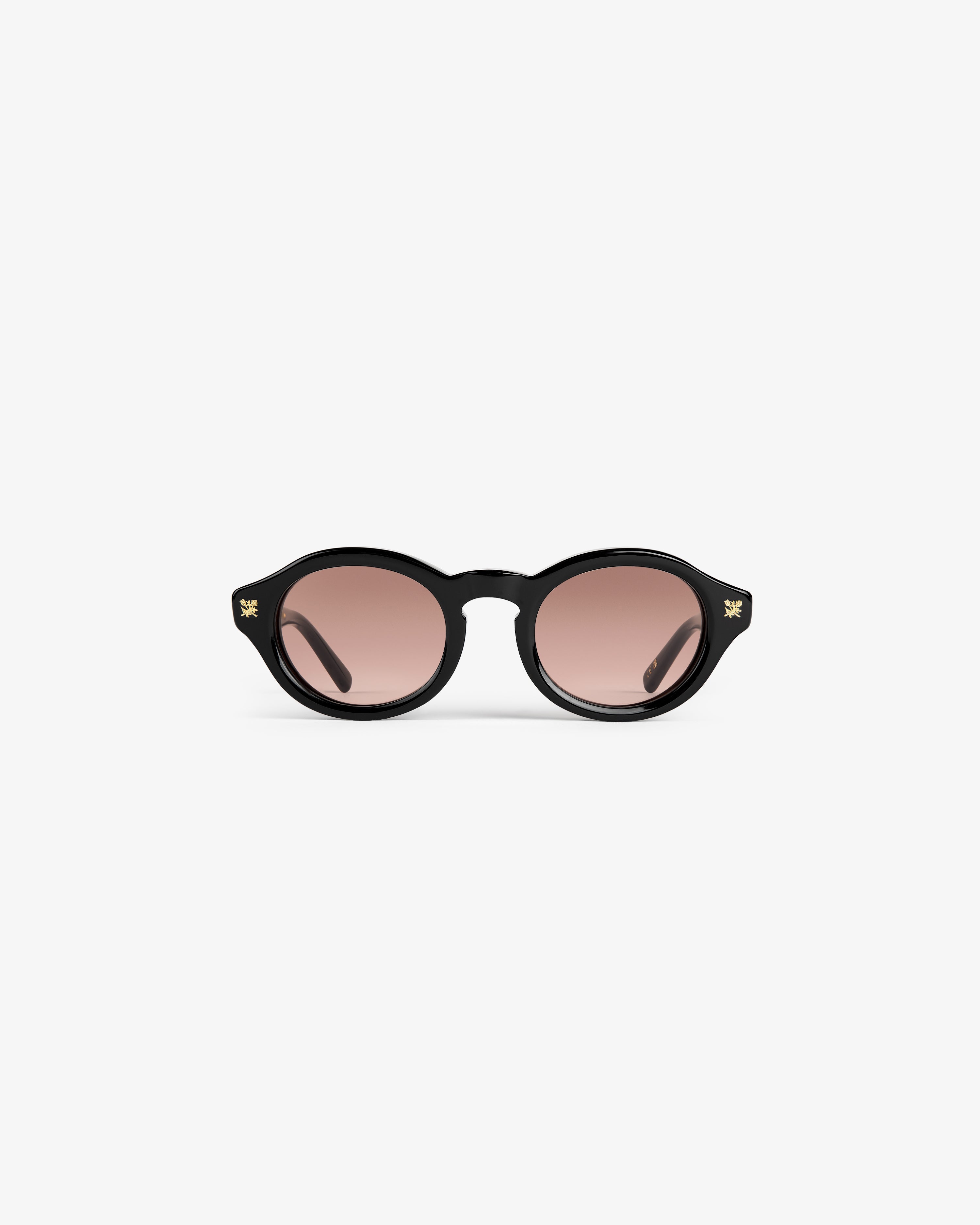 Onásis Sunglasses: round black frames with pink lenses, displayed front-facing on a plain white background.