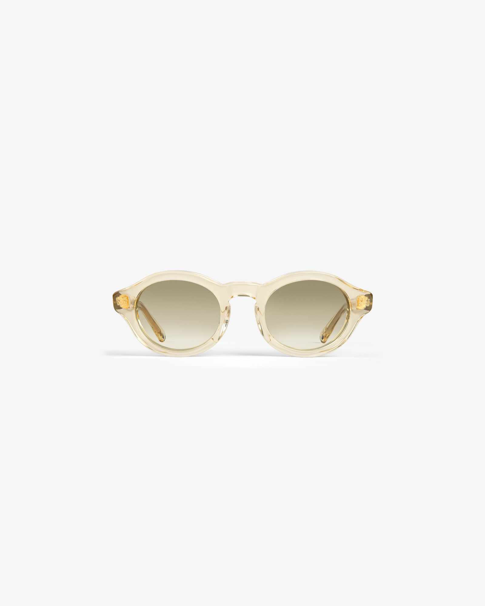 Onásis Sunglasses: Translucent, round light beige frames with gradient tinted lenses on a white background.
