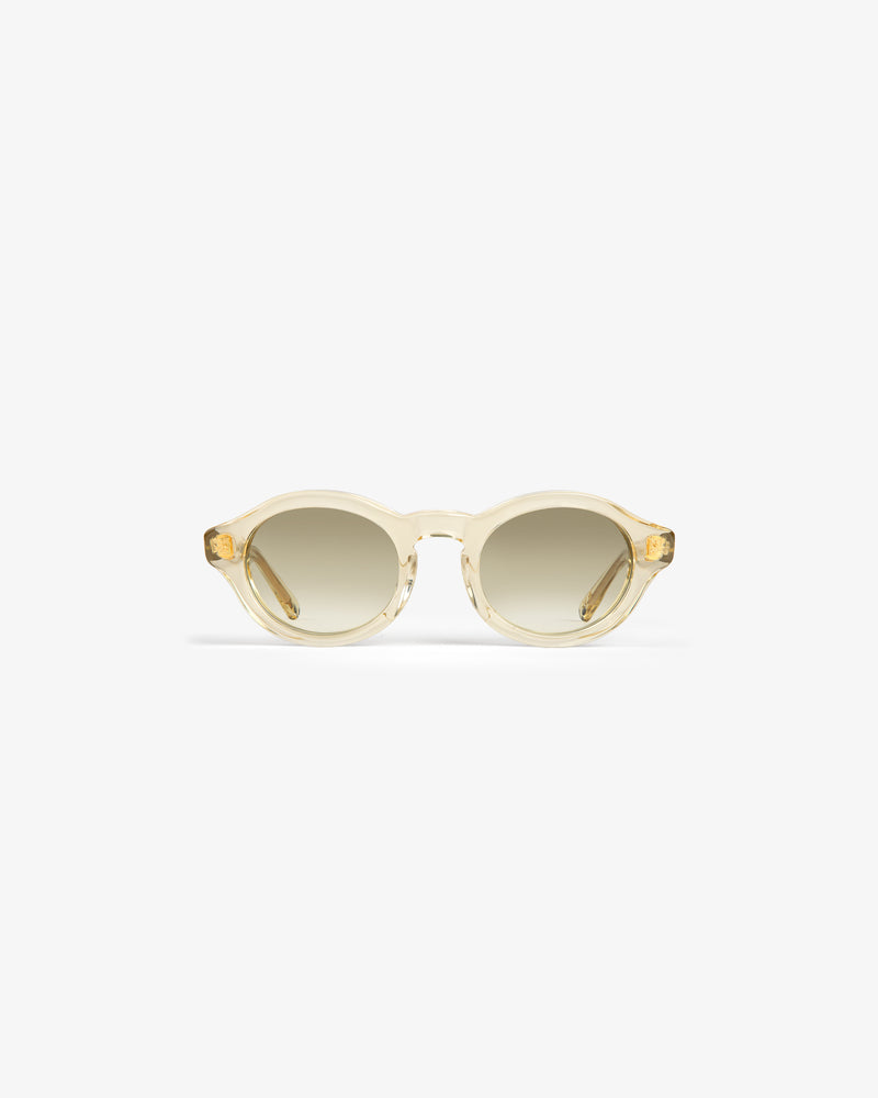 Onásis Sunglasses: Translucent, round light beige frames with gradient tinted lenses on a white background.