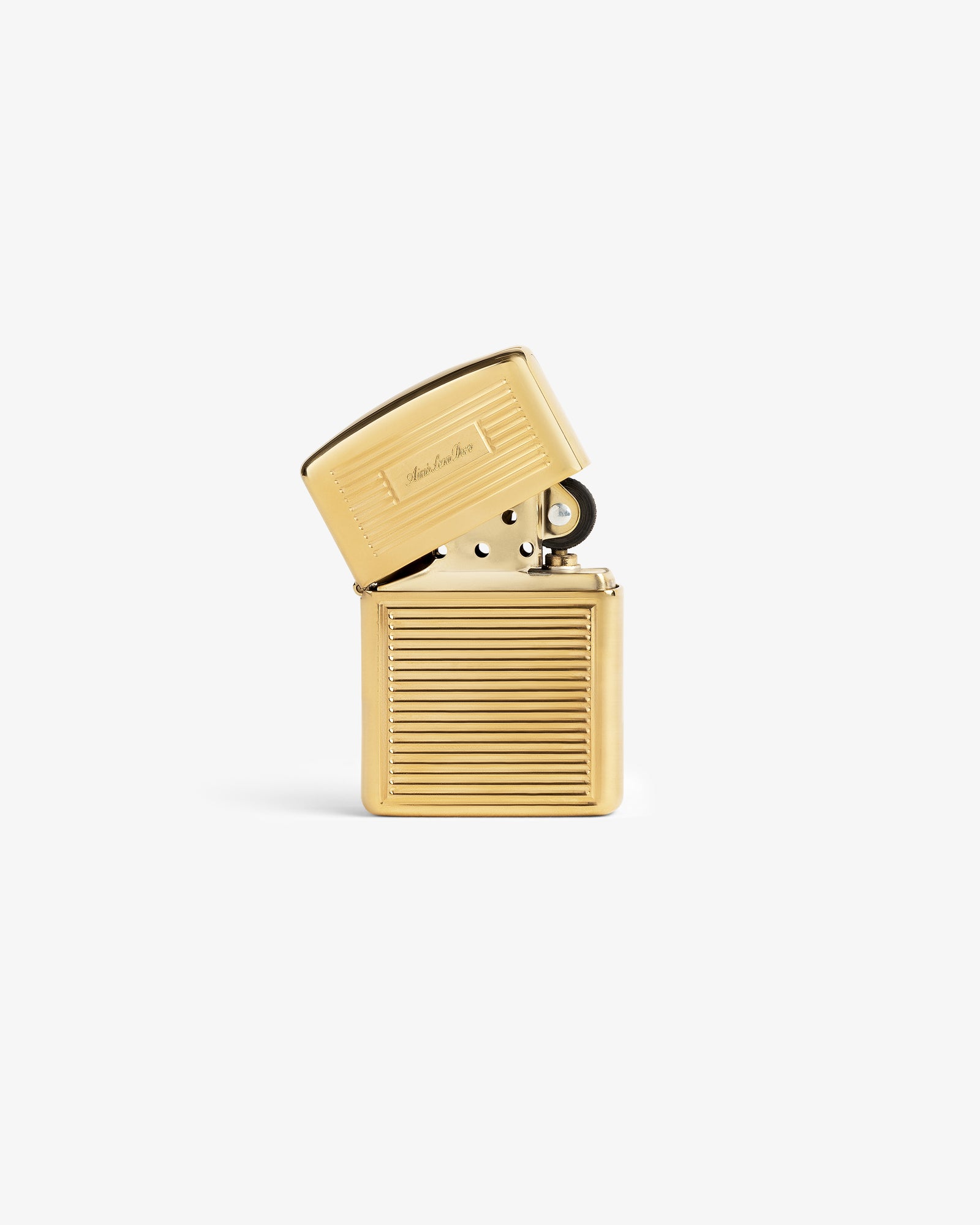 Brass Zippo Lighter with hinged lid, horizontal ridges, and engraved script on a plain white background.