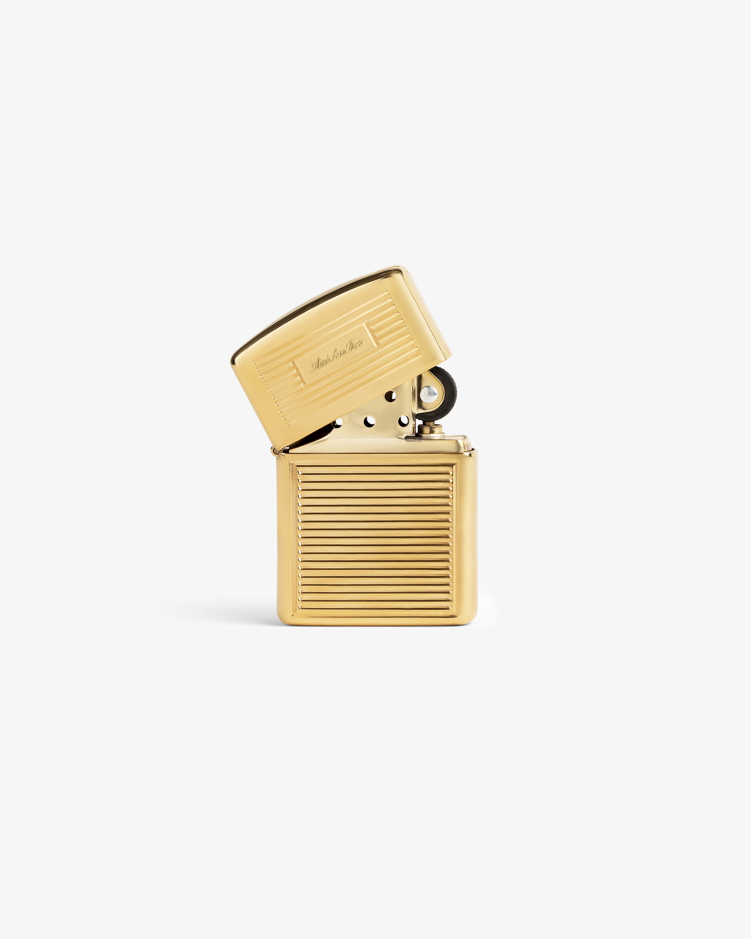 Brass Zippo Lighter with hinged lid, horizontal ridges, and engraved script on a plain white background.