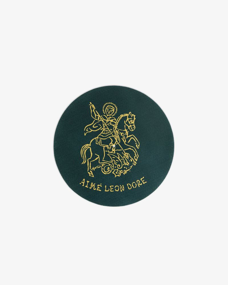 Dark green Graphic Slip Mat with a gold knight on horseback and AIMÉ LEON DORE text at the bottom.