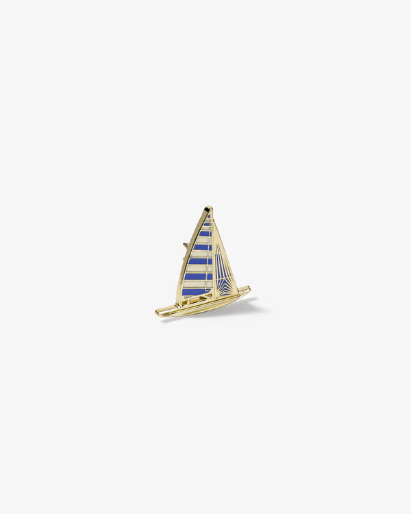 Gold and blue striped Graphic Pin in the shape of a sailboat on a plain white background.
