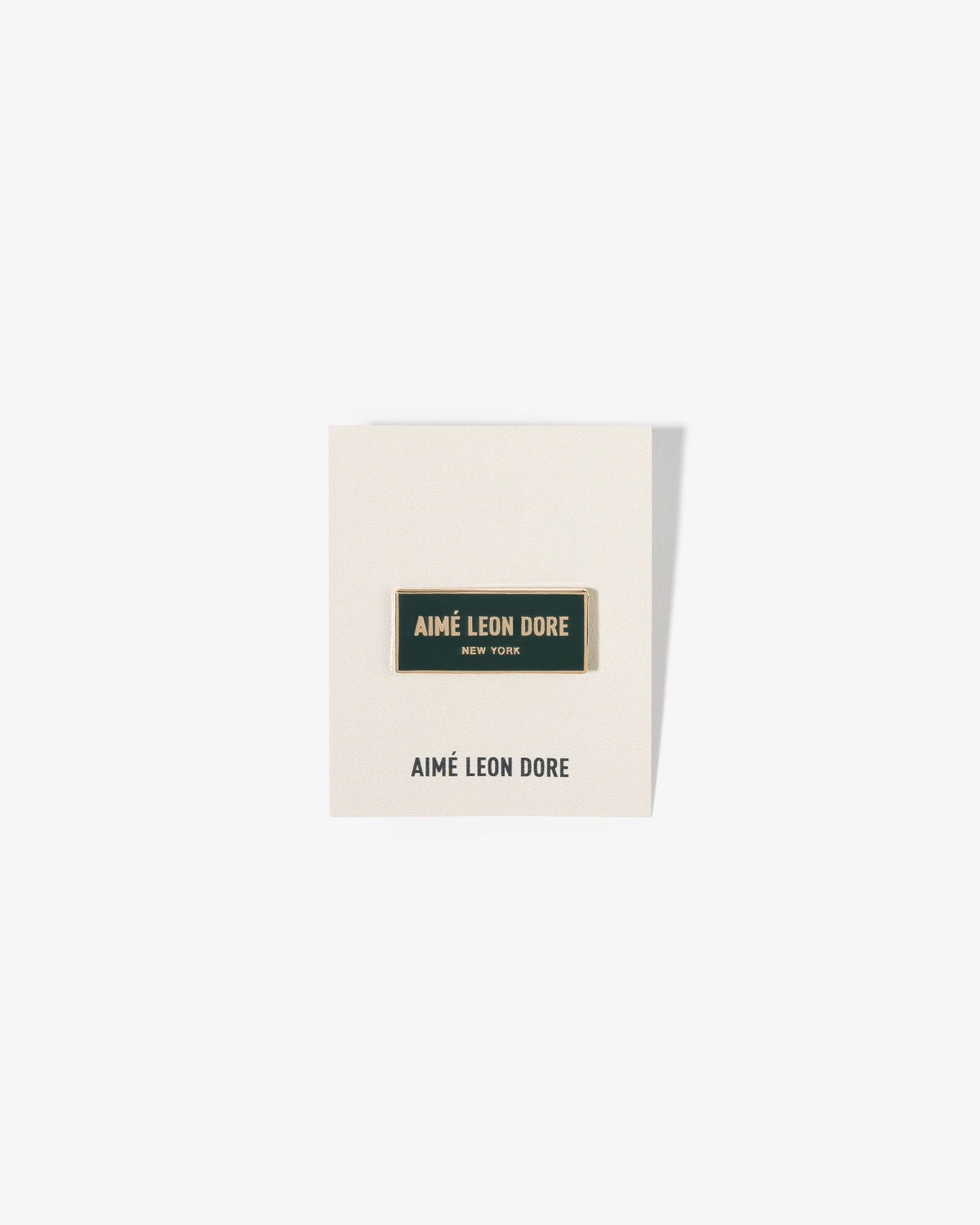 A rectangular Graphic Pin on a white card with the brand’s name printed below.