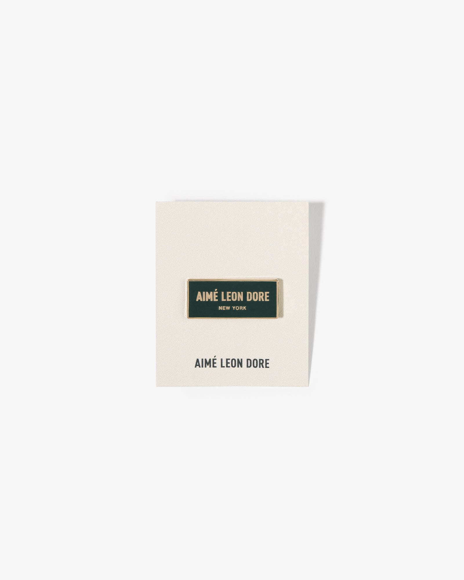 A rectangular Graphic Pin on a white card with the brand’s name printed below.