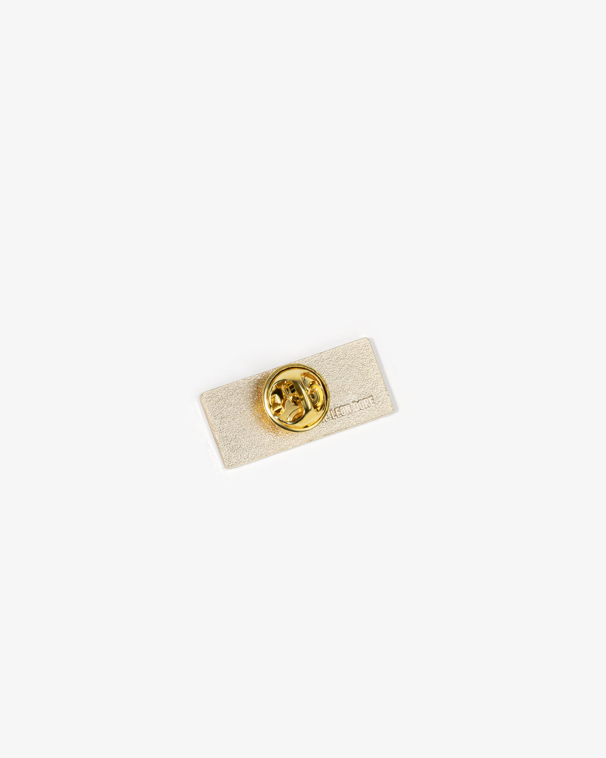 The Graphic Pin is a rectangular gold pin with a round clasp, shown on a plain white background.