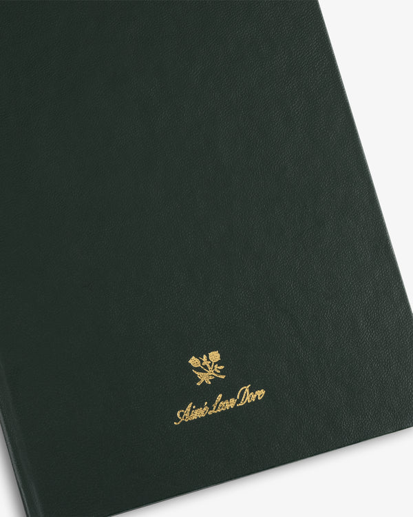 Dark green Crest Sketchbook cover with gold-stamped logo and Aimé Leon Dore script near the bottom.