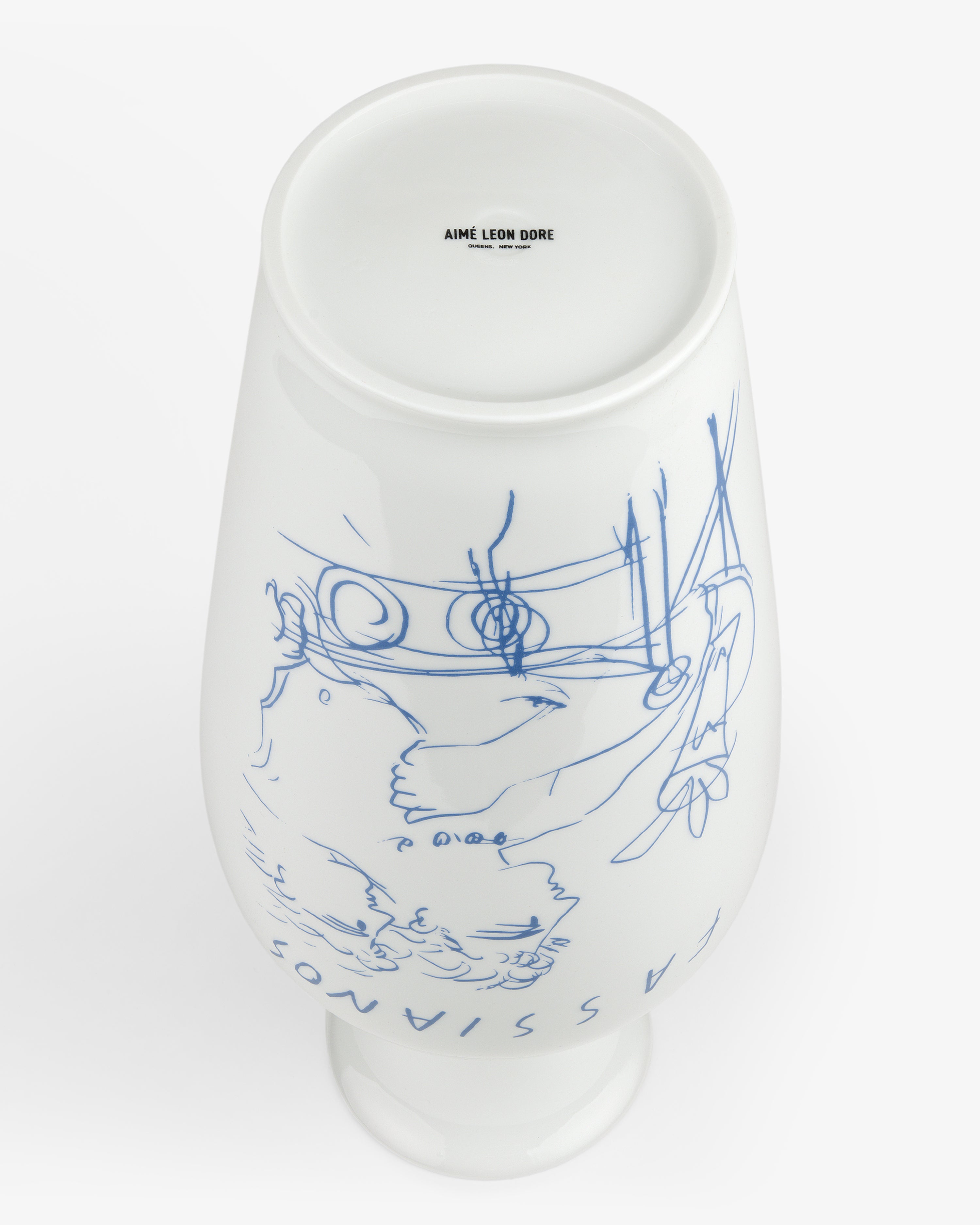Fassianos "Rendez - Vouz" Vase: white ceramic with blue line art, “AIME LEON DORE” on the base, shown upside down.