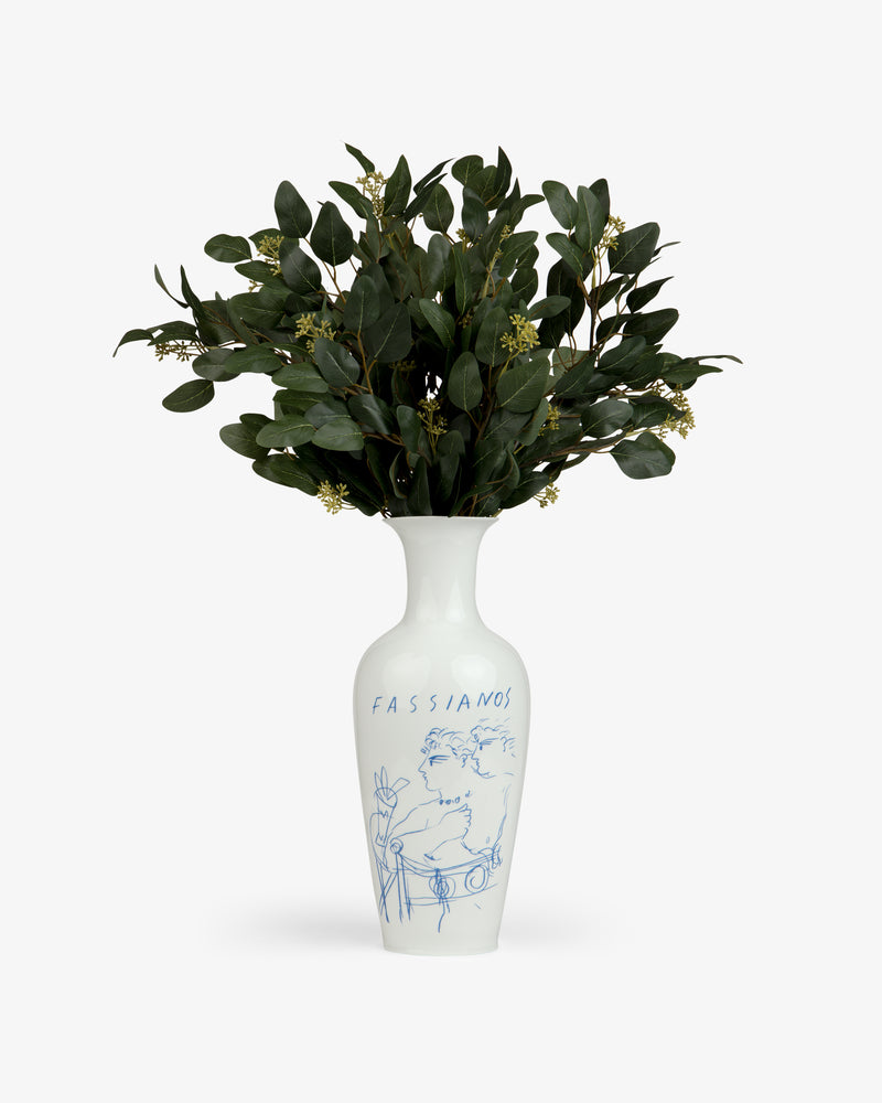 Fassianos "Rendez - Vouz" Vase with blue line art, holding green leafy branches and small white flowers.