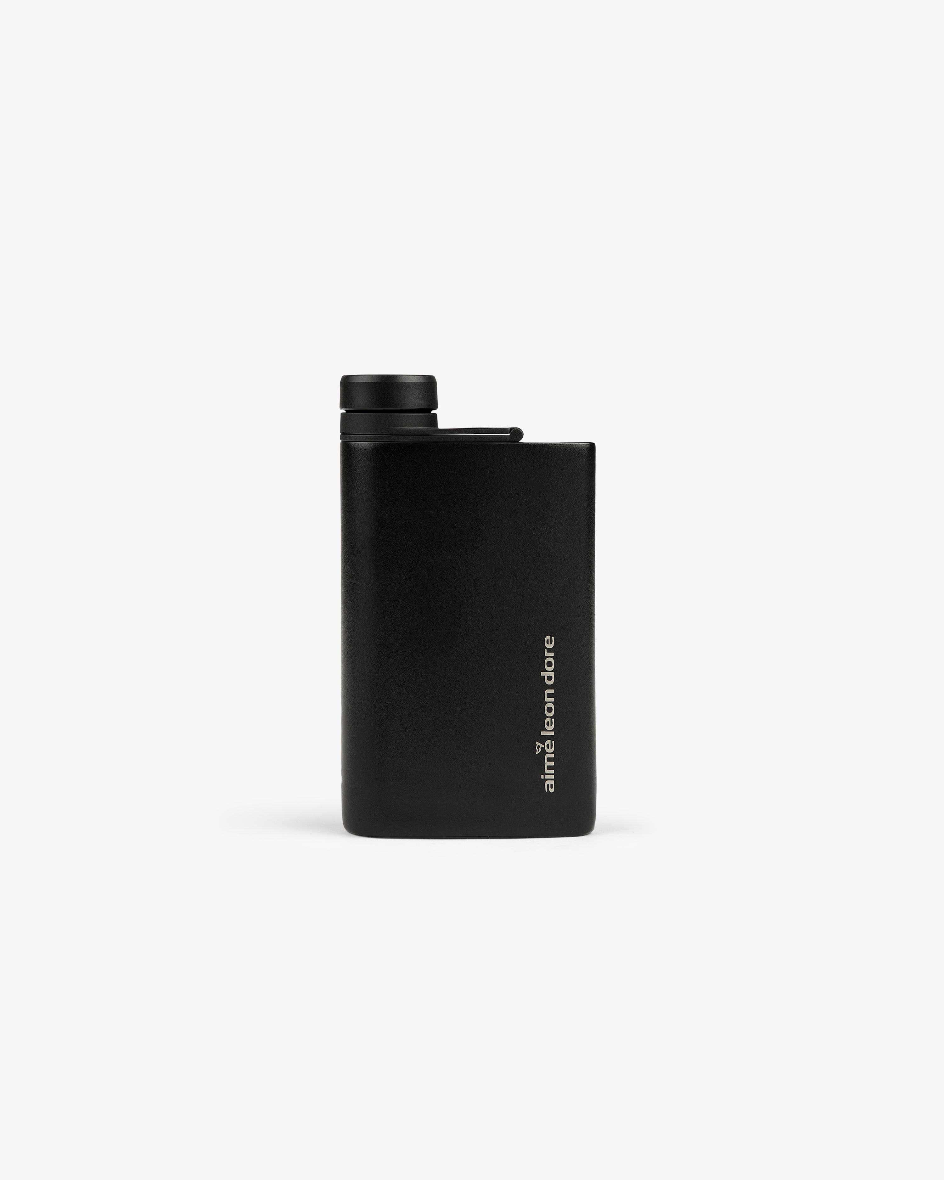 ALD Golf 19th Flask: a slim black flask with a screw cap and "aimé leon dore" written vertically near the bottom.