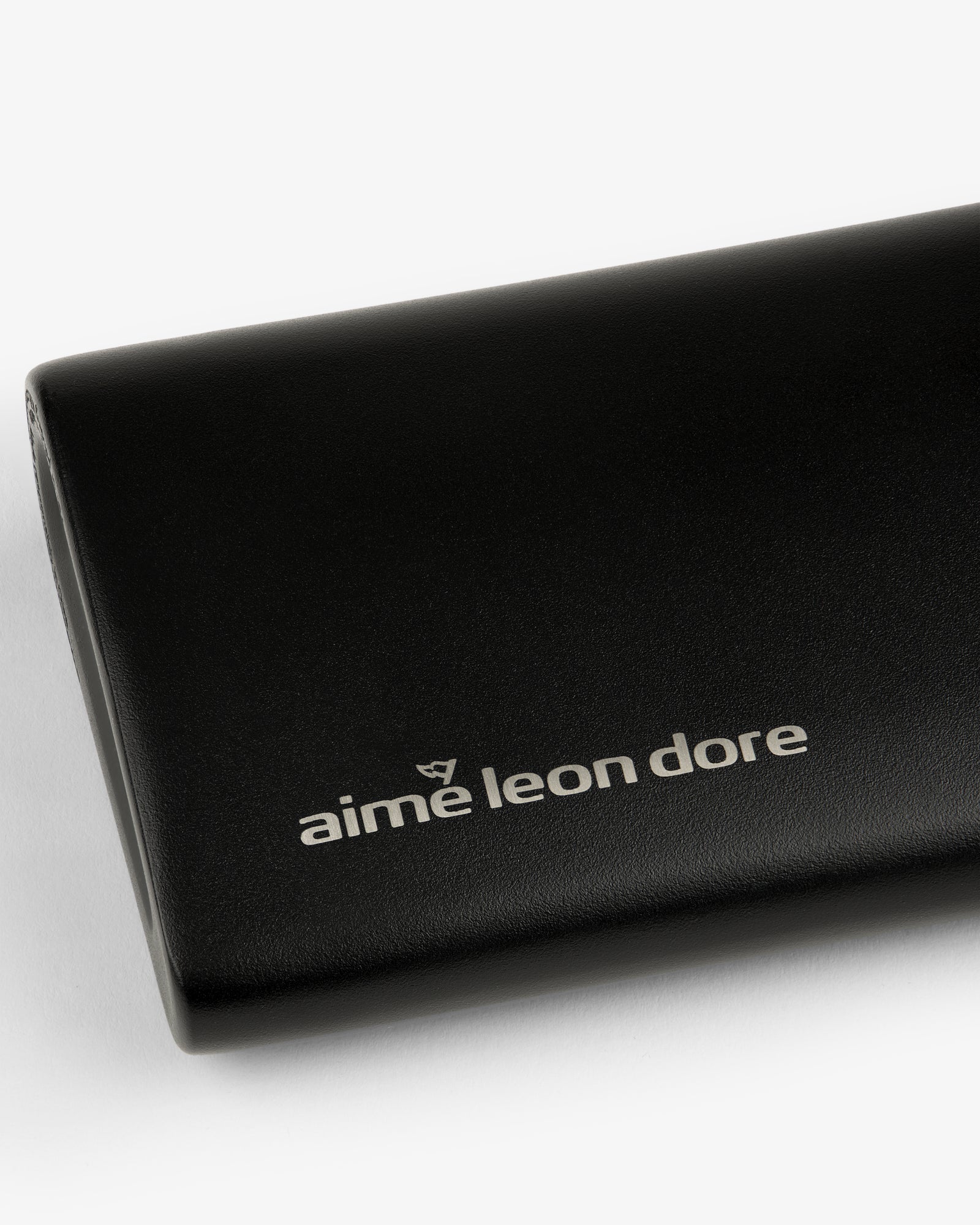 Black leather ALD Golf 19th Flask case featuring the aime leon dore logo in white on the front.