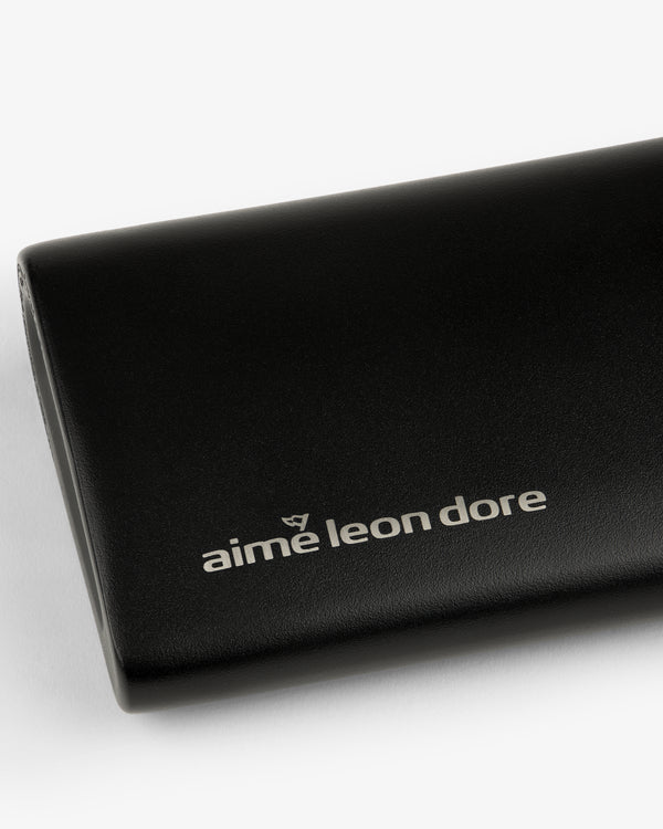 Black leather ALD Golf 19th Flask case featuring the aime leon dore logo in white on the front.