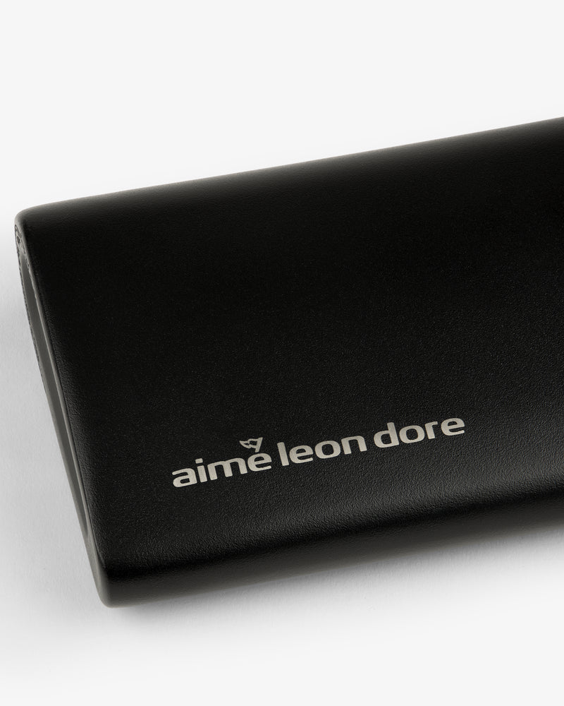 Black leather ALD Golf 19th Flask case featuring the aime leon dore logo in white on the front.