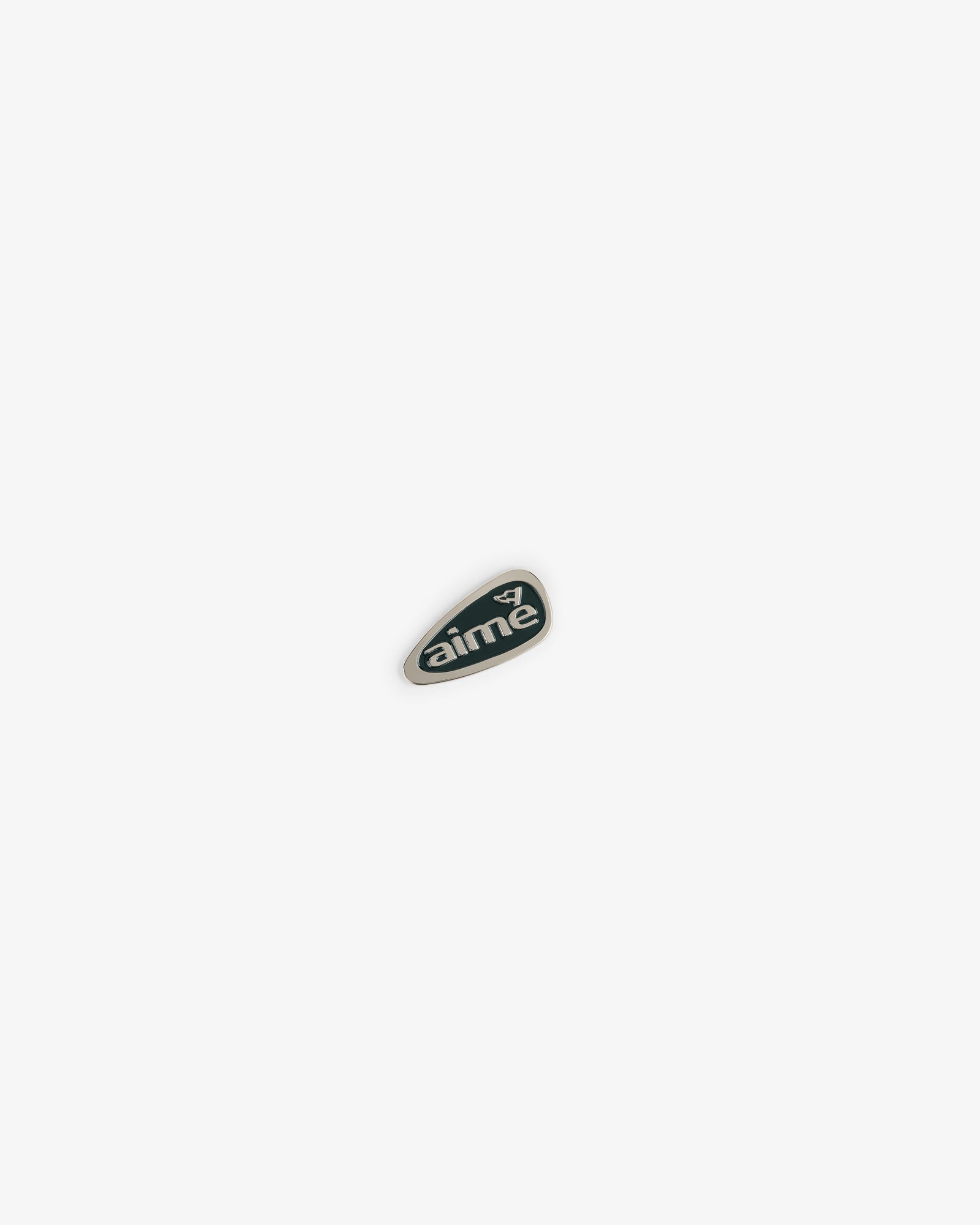 A small, dark green ALD Golf Divot Tool with "aimé" and a white graphic, centered on a white background.