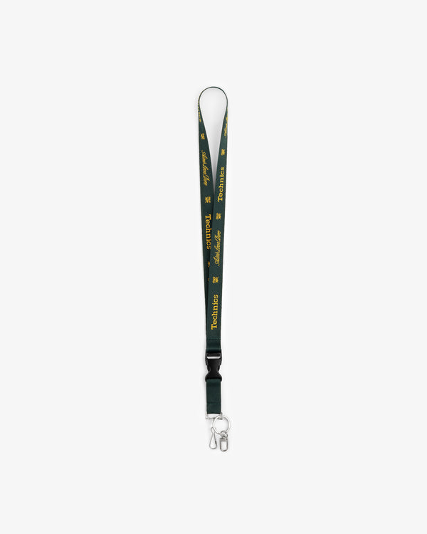 ALD / Technics Lanyard with green strap, yellow text, logo, metal clip, and keyring on a white background.
