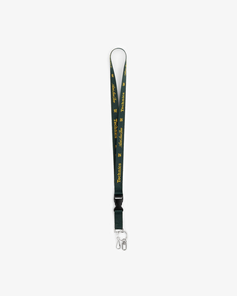 ALD / Technics Lanyard with green strap, yellow text, logo, metal clip, and keyring on a white background.
