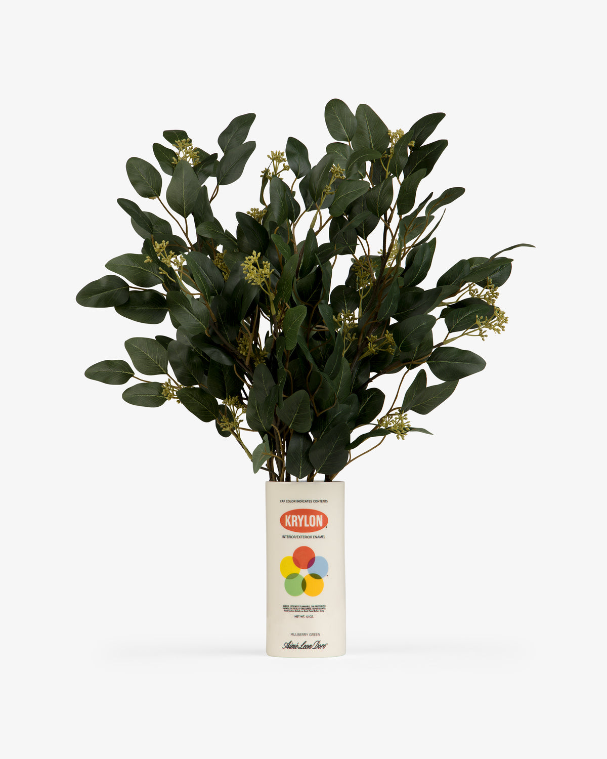 A leafy green plant sits in a Krylon Ceramic Spray Can Vessel, used as a vase, against a white background.