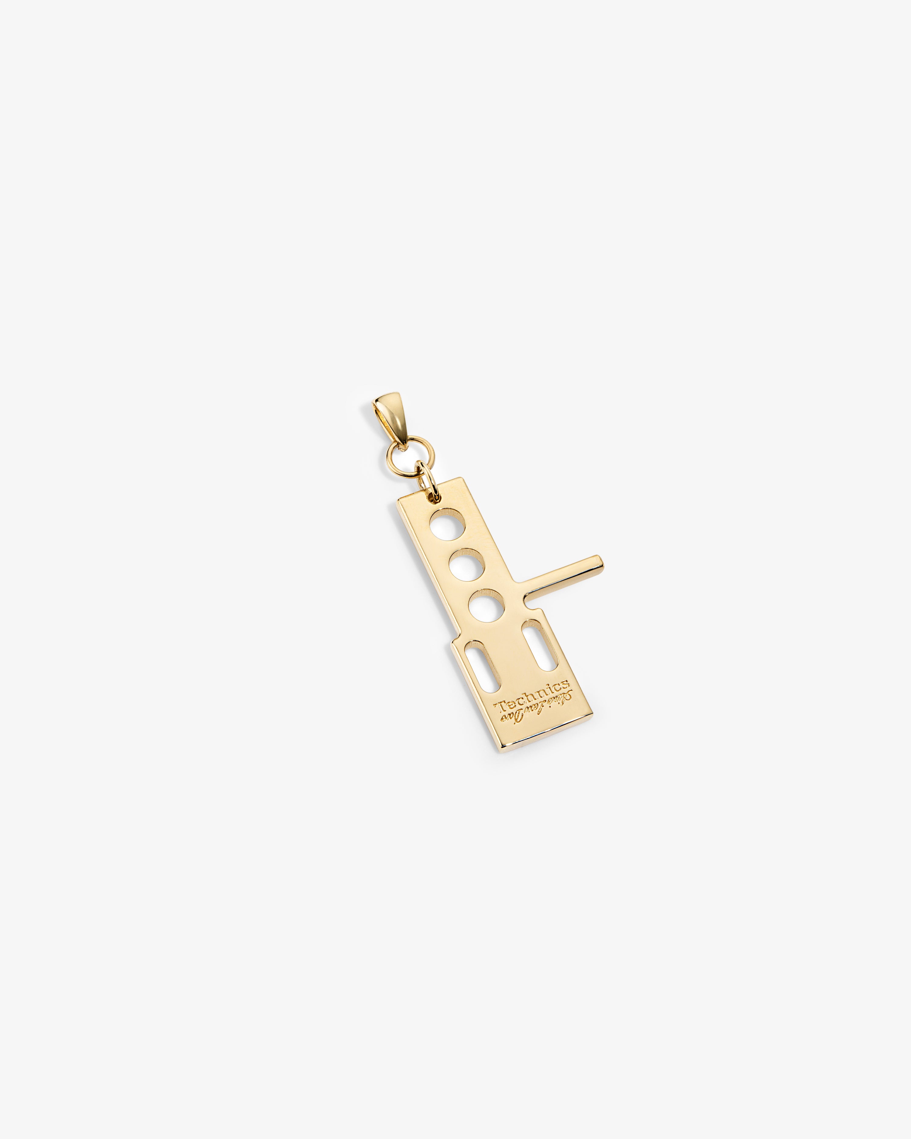 ALD / Technics 14Kt Gold Pendant with geometric cutouts and engraved text on a white background.