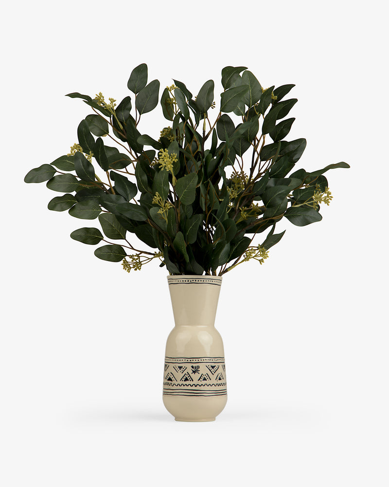 A cream-colored Textile Patterned Vase with green branches and small yellow flowers on a white background.