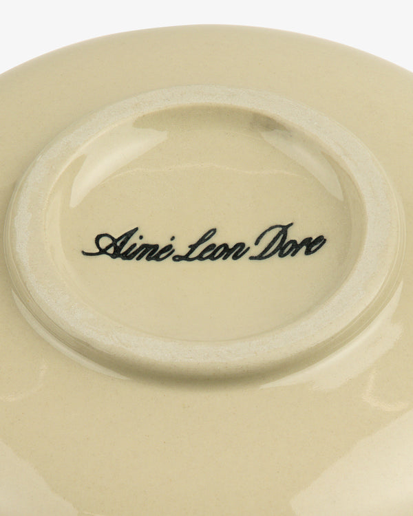 Textile Patterned Bud Vase with beige ceramic base, Aime Leon Dore script in black at the center.