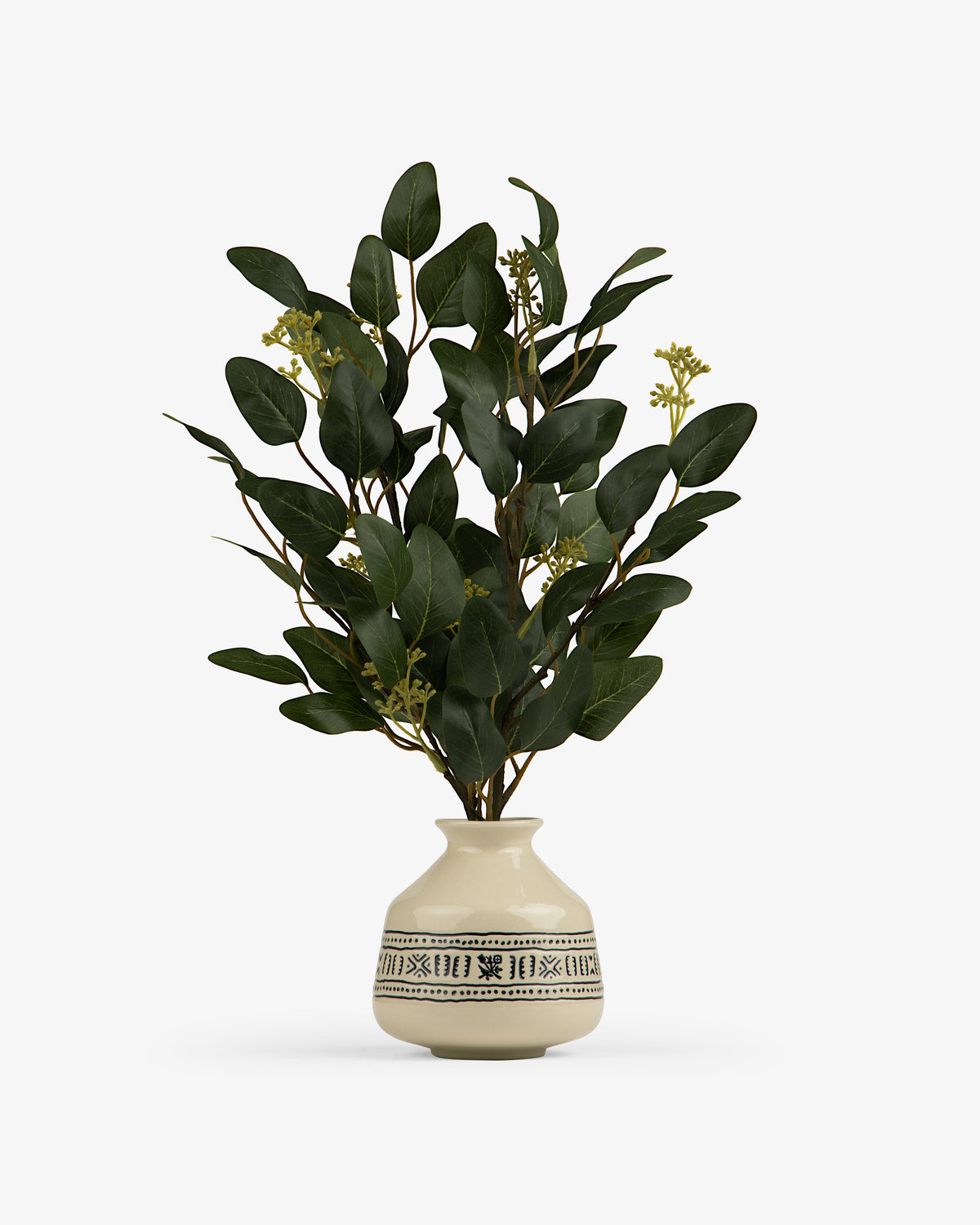 The Textile Patterned Bud Vase displays green leafy branches with small yellow buds.