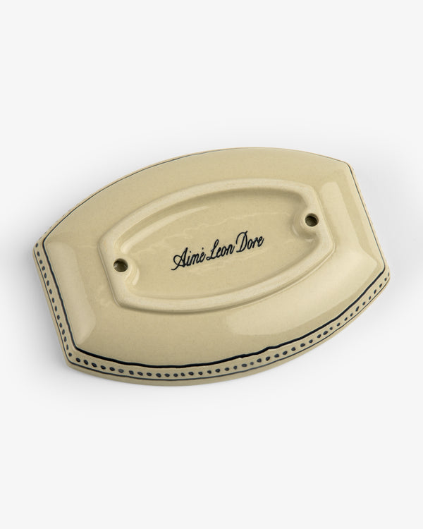 Beige Crest Catchall with two holes, blue trim, and Aimé Leon Dore in script on top.