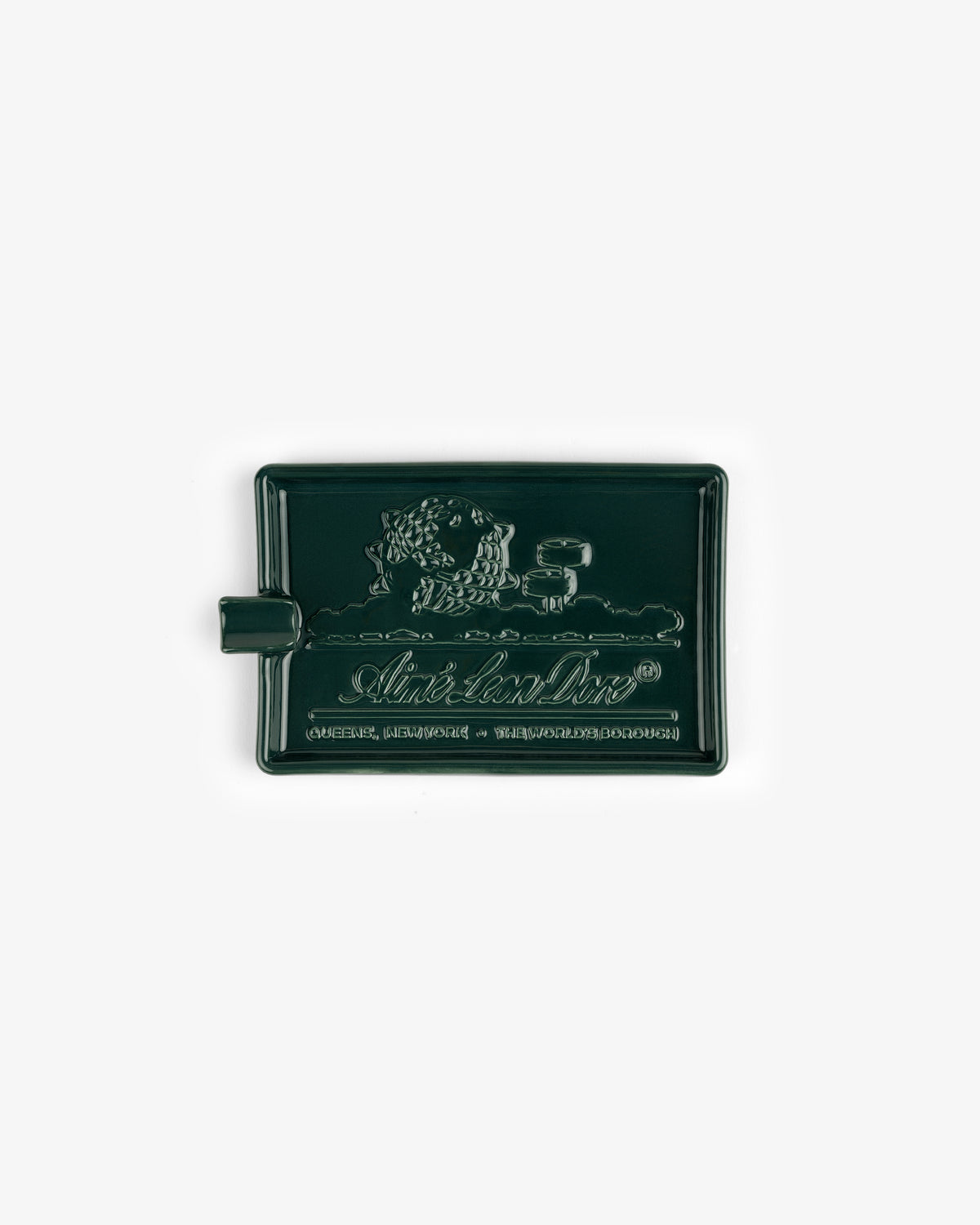 Ceramic Unisphere Ashtray in dark green, rectangular with raised lion design, handle on the left side.