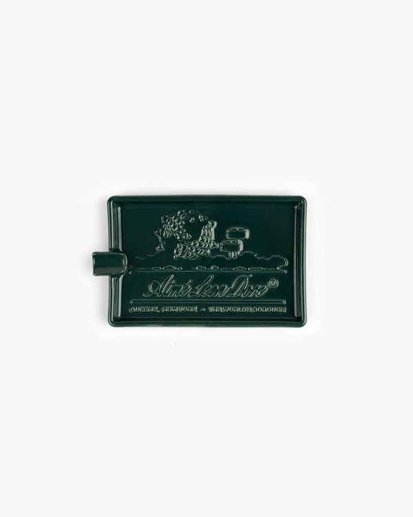 Ceramic Unisphere Ashtray in dark green, rectangular with raised lion design, handle on the left side.