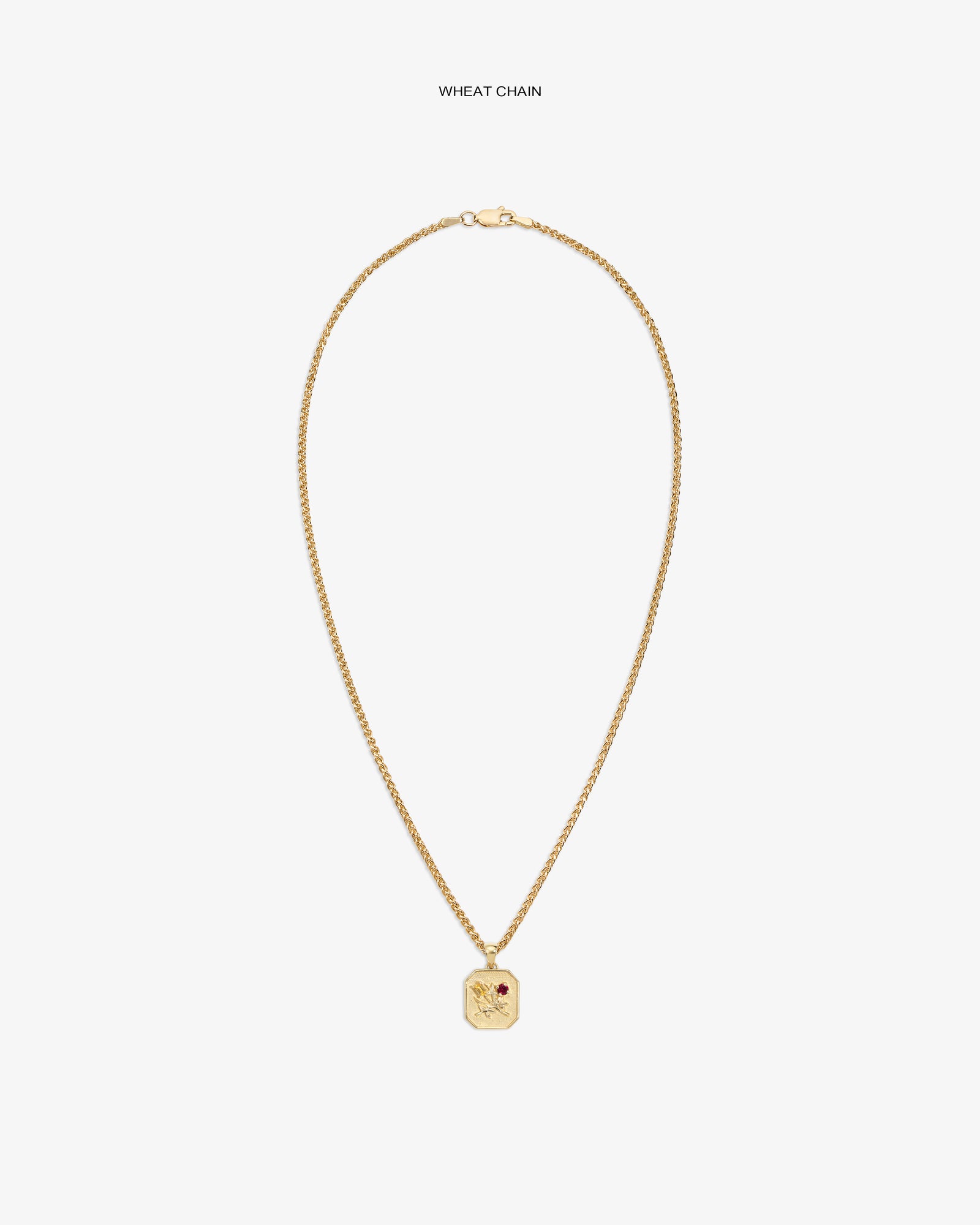 14Kt gold wheat chain necklace with Queens Crest Relief pendant and a small red gem accent.