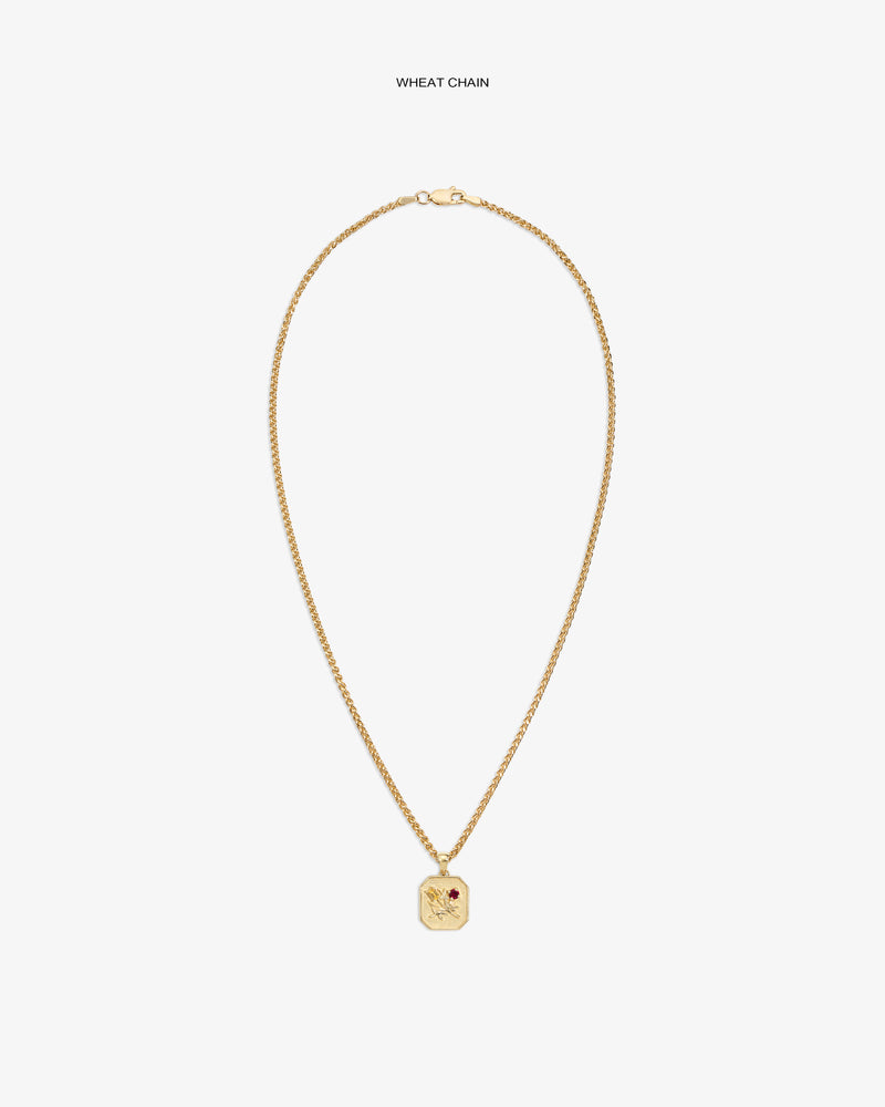 14Kt gold wheat chain necklace with Queens Crest Relief pendant and a small red gem accent.