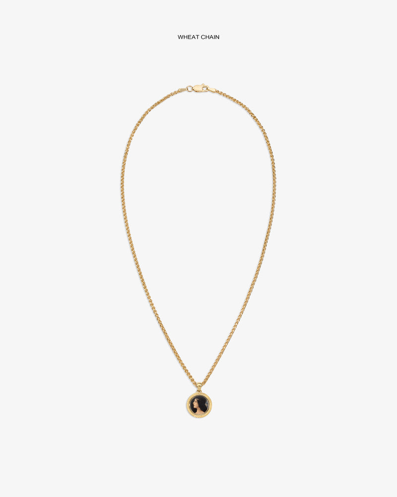14Kt Gold Hera Pendant on a wheat chain with a black and gold round pendant, shown on a plain white background.