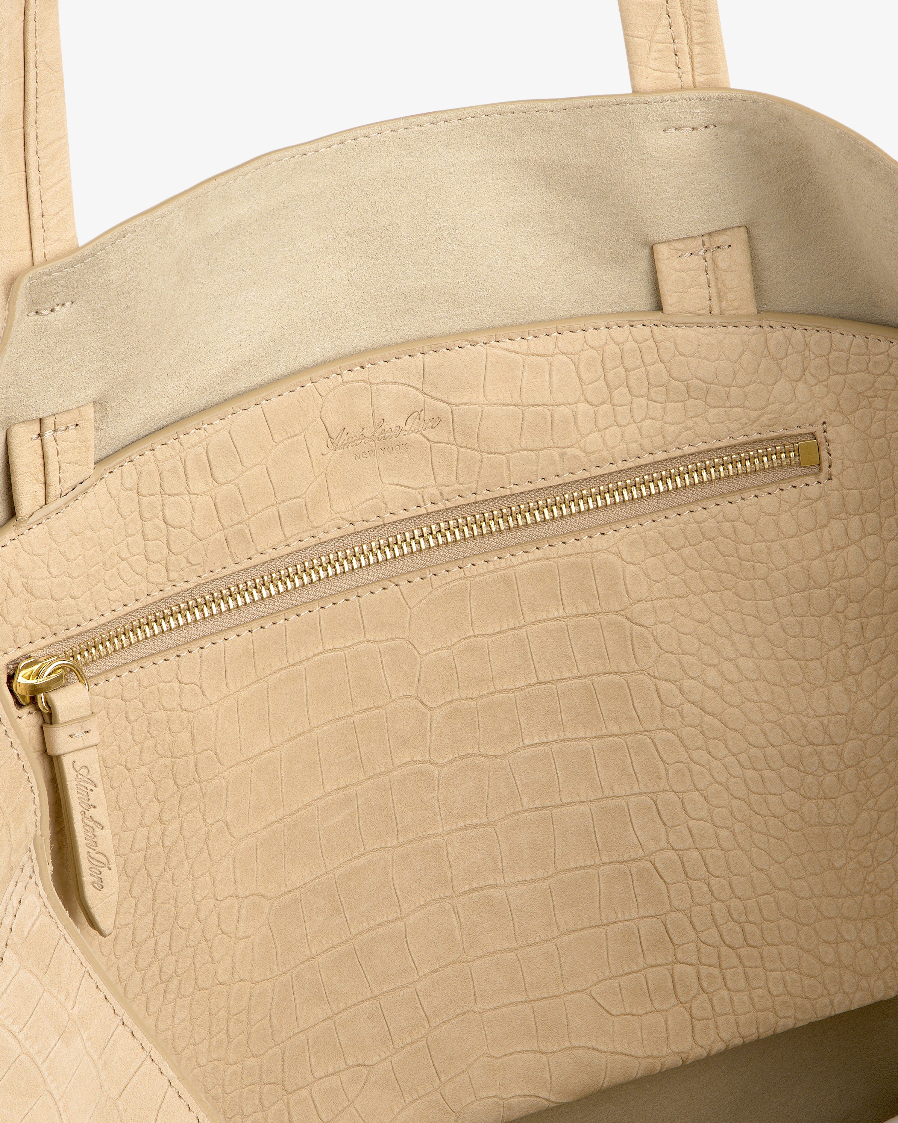 Close-up of the Croc-Embossed Nubuck Tote Bag with a gold zipper pocket and soft suede interior.