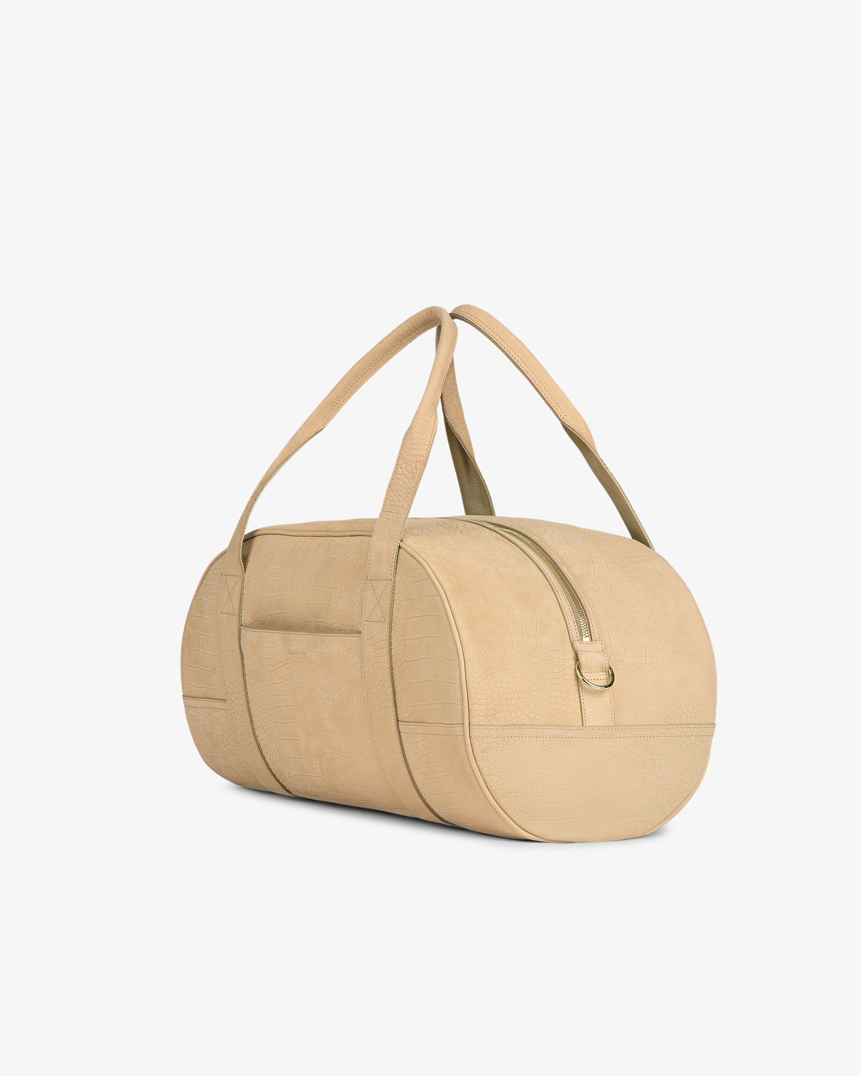 Croc-Embossed Nubuck Duffle, beige and cylindrical with two handles and a front pocket, on a white background.