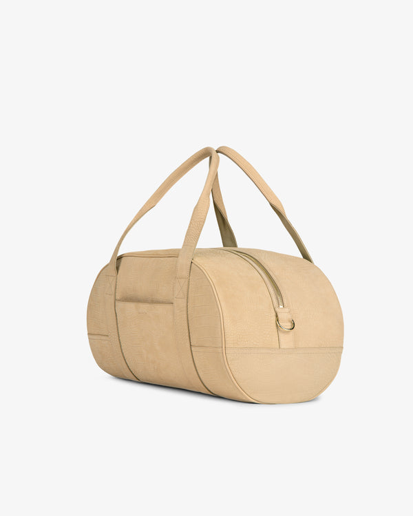 Croc-Embossed Nubuck Duffle, beige and cylindrical with two handles and a front pocket, on a white background.