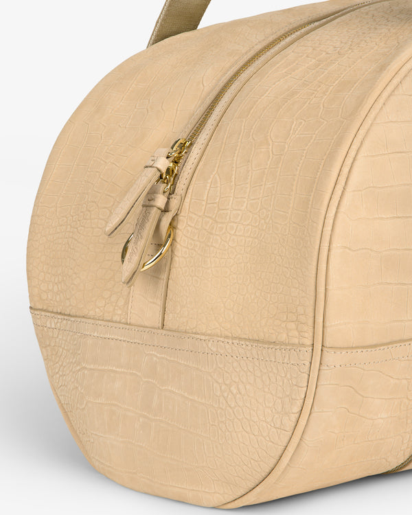 Croc-Embossed Nubuck Duffle in beige with gold zipper and leather pull tabs, shown in a close-up.