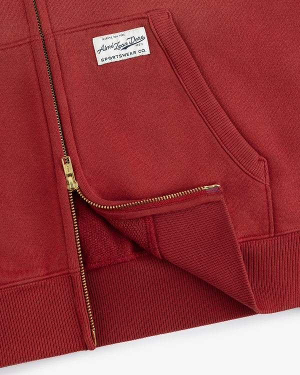 Sun Faded Full-Zip Hoodie in red with gold zipper, front pocket, and white Ambler Power Drive SPORTSWEAR CO. label.