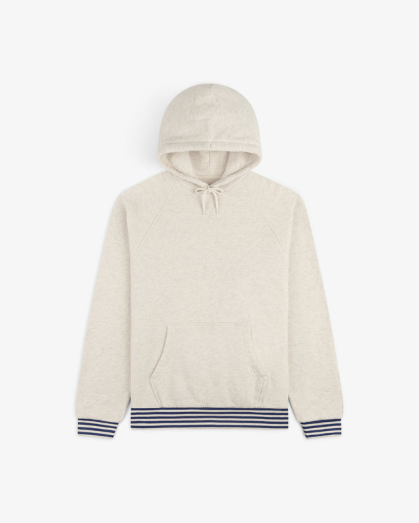Dock Hoodie in beige with front pocket and navy striped cuffs and hem, shown flat on a white background.