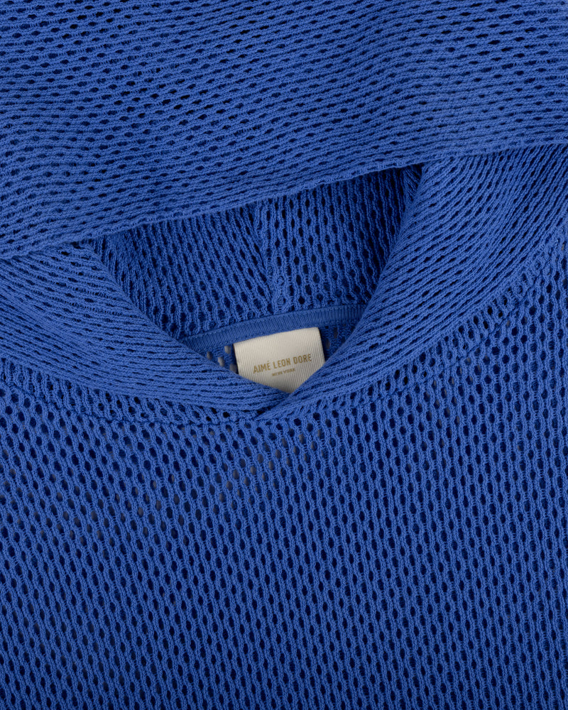 Close-up of an Open Mesh Hoodie in blue with a visible white clothing label inside the neckline.
