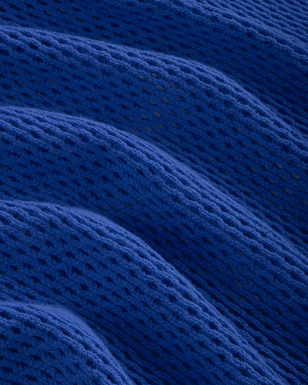 Close-up of Open Mesh Hoodie in blue, showing its textured mesh pattern arranged in soft, wavy folds.