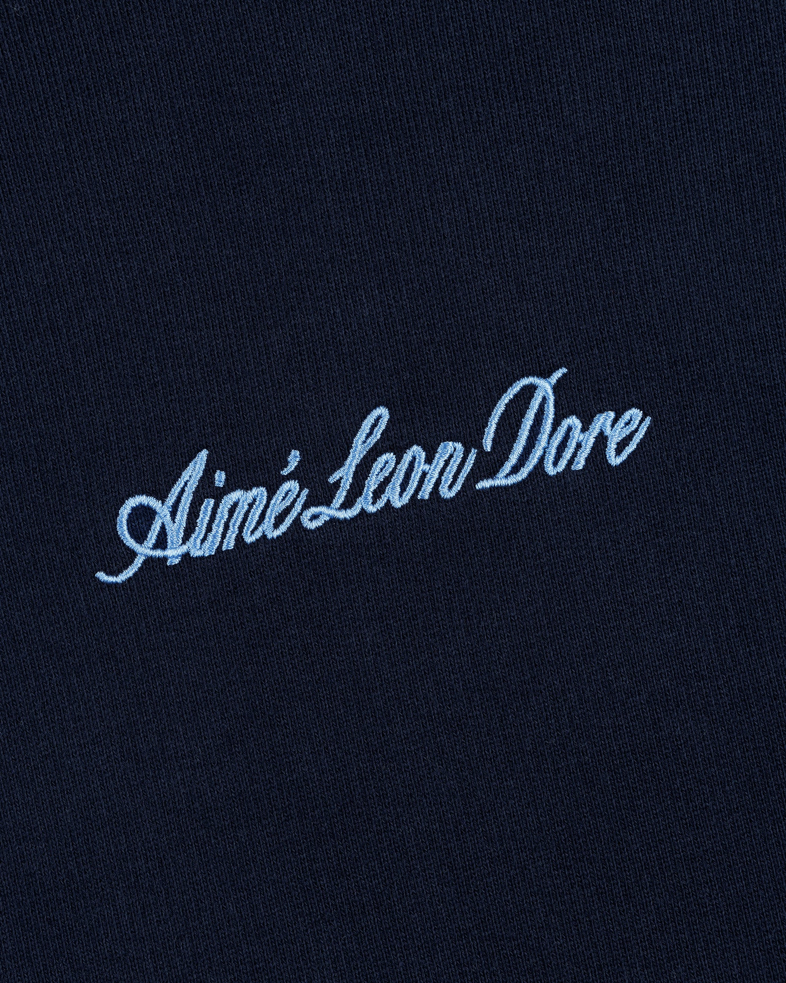 Navy blue Embroidered Logo Hoodie with Aimé Leon Dore in light blue cursive embroidery.