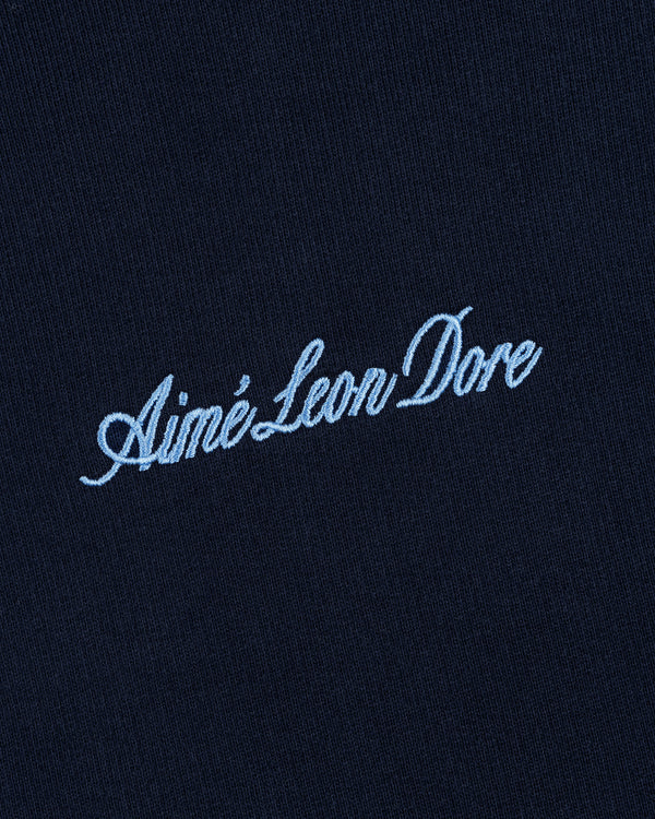 Navy blue Embroidered Logo Hoodie with Aimé Leon Dore in light blue cursive embroidery.