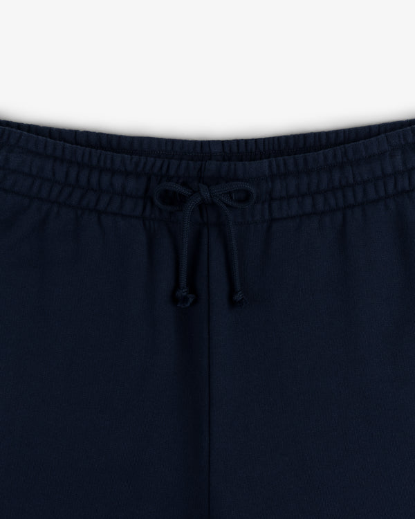 Close-up of the waistband of Crest Sweatpants in navy blue, featuring a front bow-tied drawstring.