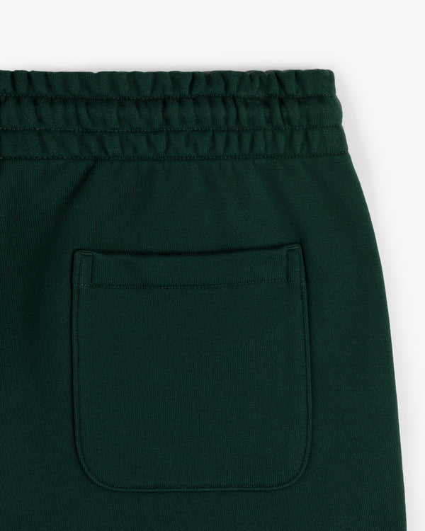 Close-up of the back pocket and elastic waistband on Crest Sweatpants in dark green.