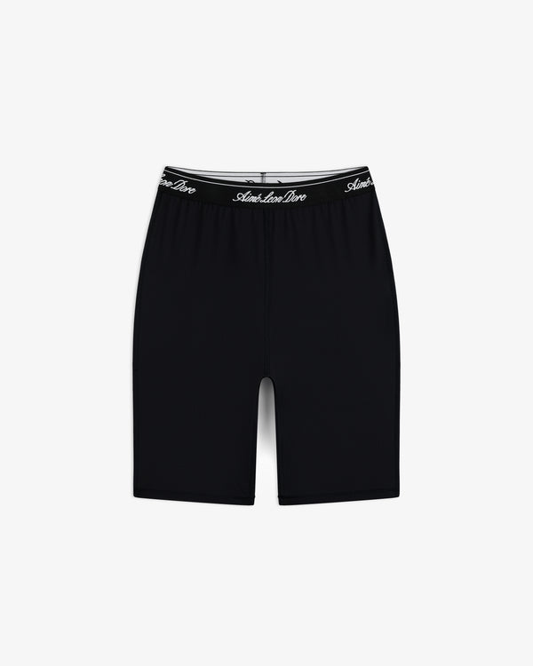 Logo Biker Short: Black, knee-length fitted shorts with a black elastic waistband and white script text.