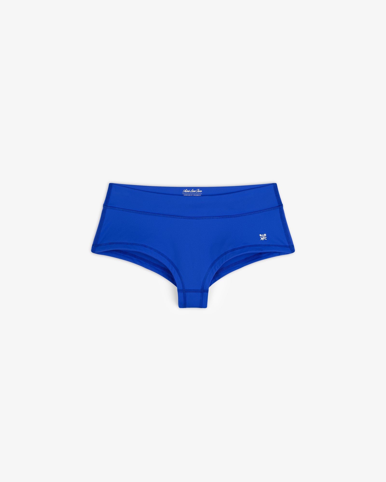 Crest Swim Short in bright blue, women's boyshort style, laid flat showing small left-hip logo on white background.