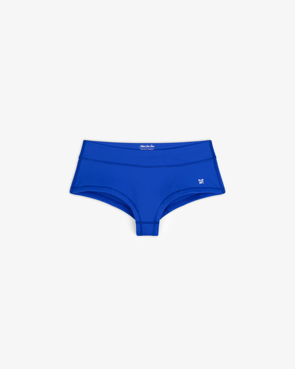 Crest Swim Short in bright blue, women's boyshort style, laid flat showing small left-hip logo on white background.