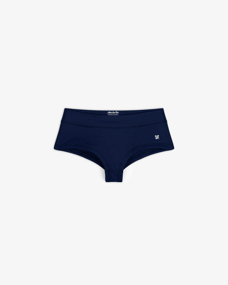 Navy blue Crest Swim Short for women with a small white logo on the left, shown on a white background.