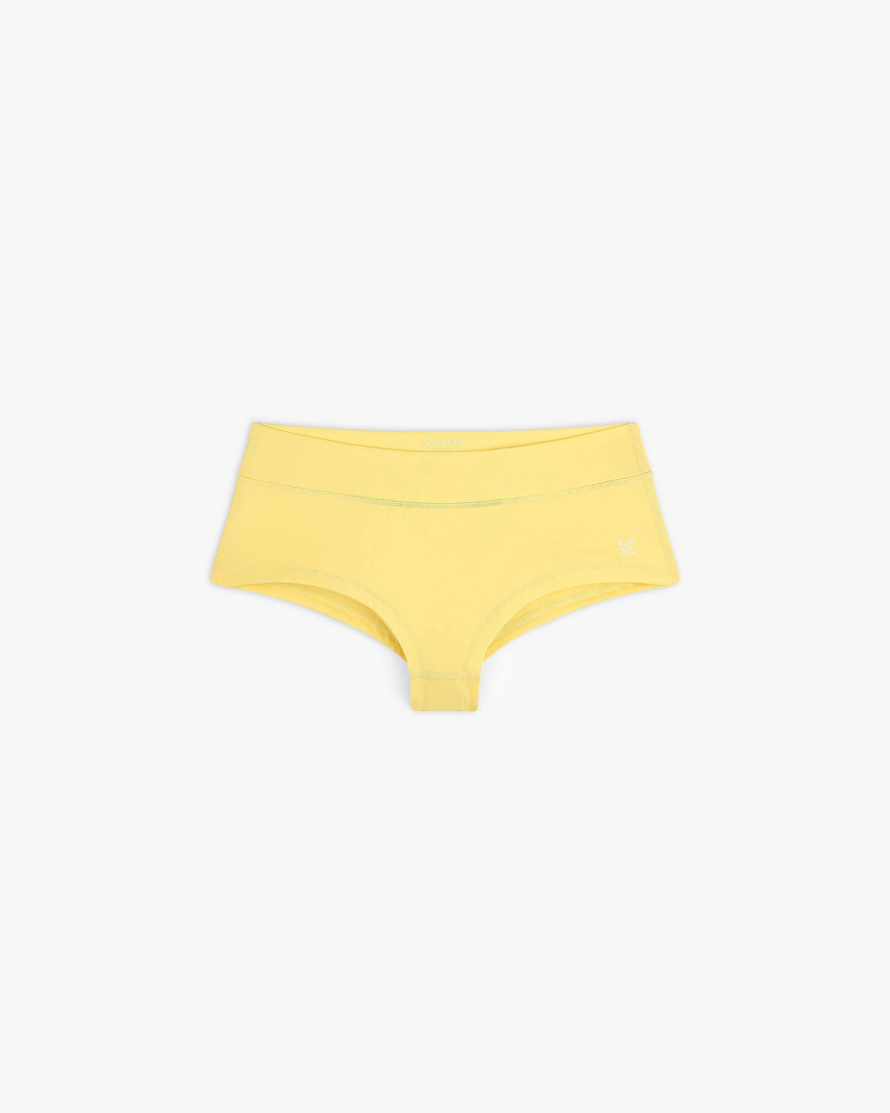 Yellow Crest Swim Short for women laid flat on a plain white background.